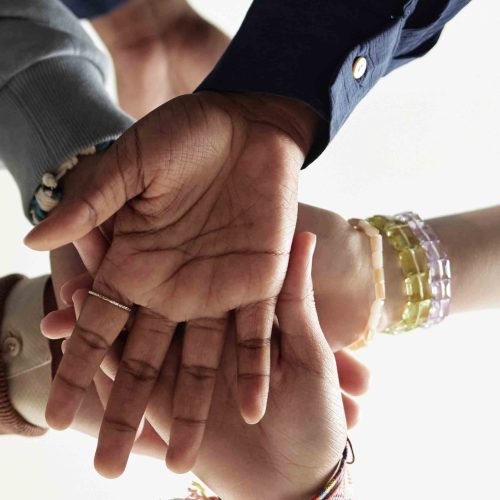 Header Image Group of Children Stacking Hands